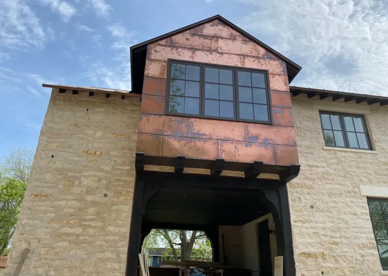 Copper metal panel facade on a stone building for Skylight Installation in Sebastian